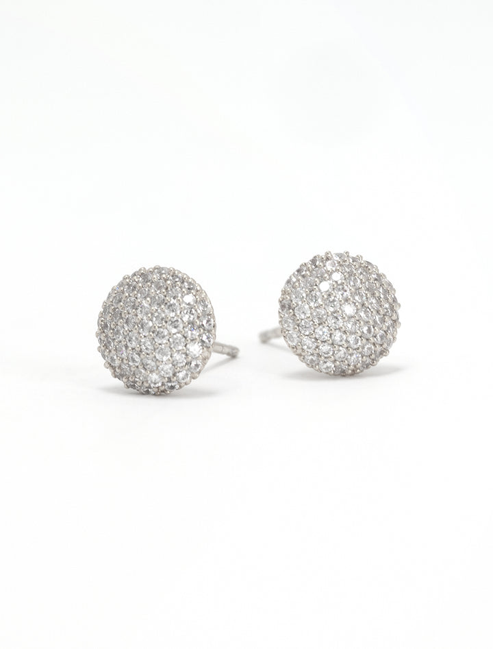 Close-up view of Tai's cz button stud earrings in silver.