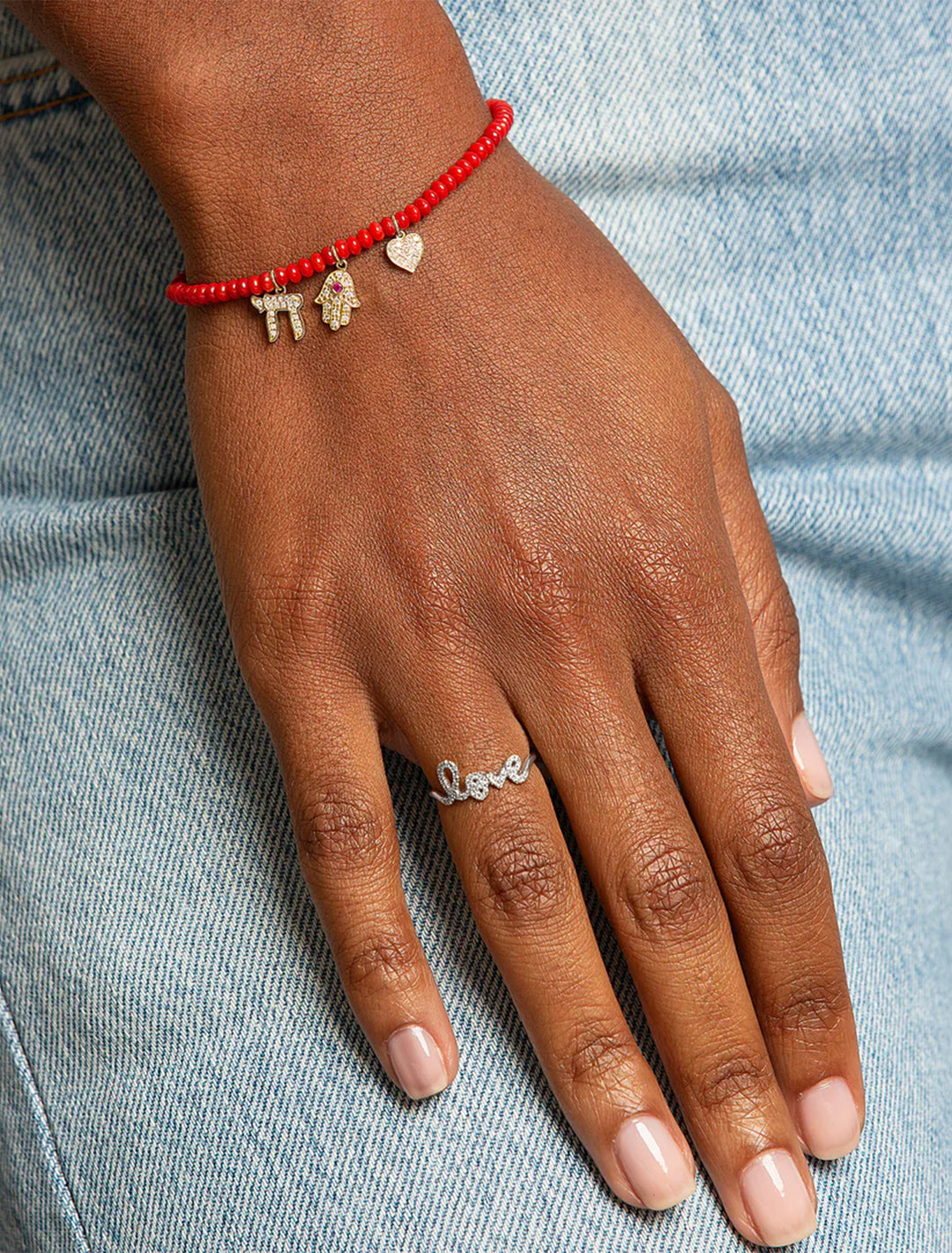 Model wearing Sydney Evan's love script ring in white gold.