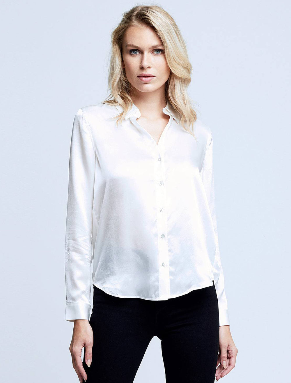 Model wearing L'agence's tyler blouse in ivory.