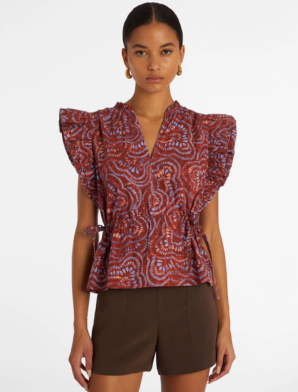Model wearing Marie Oliver's olive top in cranberry burst.