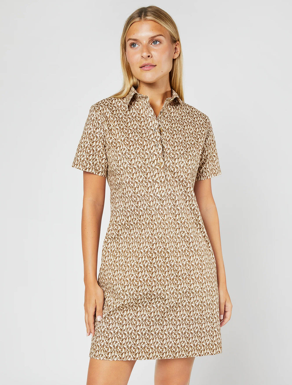 Model wearing Ann Mashburn's short sleeved popover dress in giraffe print.