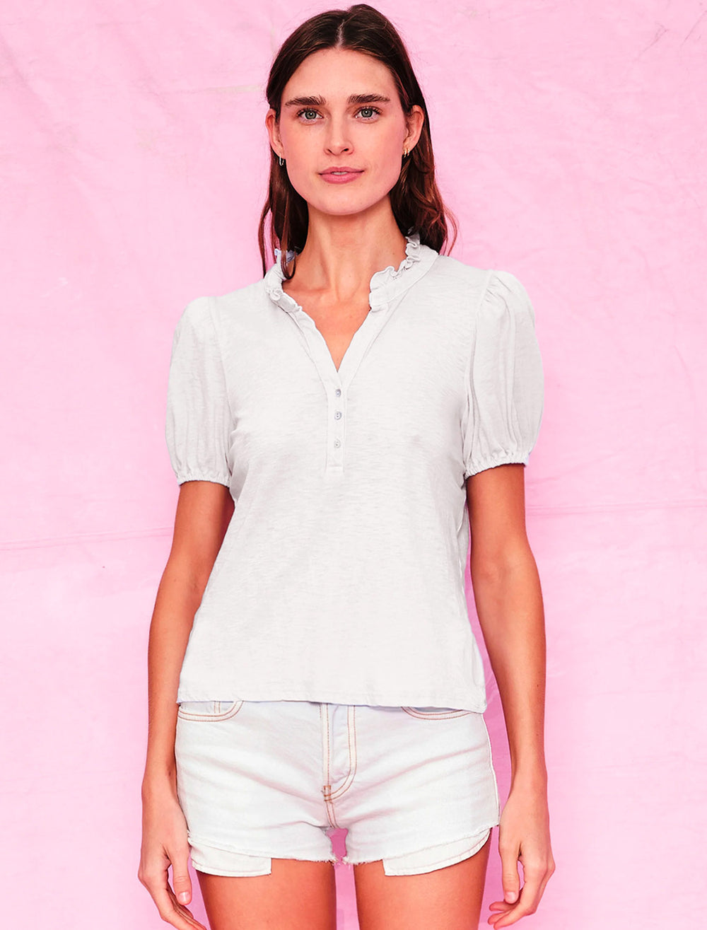 Model wearing Sundry's short sleeve ruffleneck henley in white.