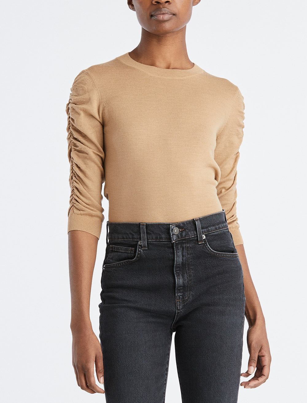 Model wearing Veronica Beard's kase pullover in camel.