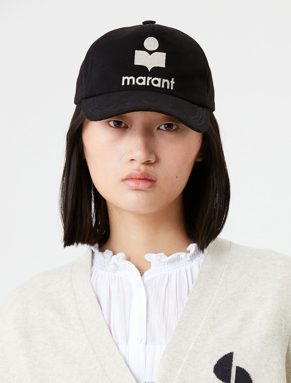Model wearing isabel marant etoile's tyron cap in black and ecru