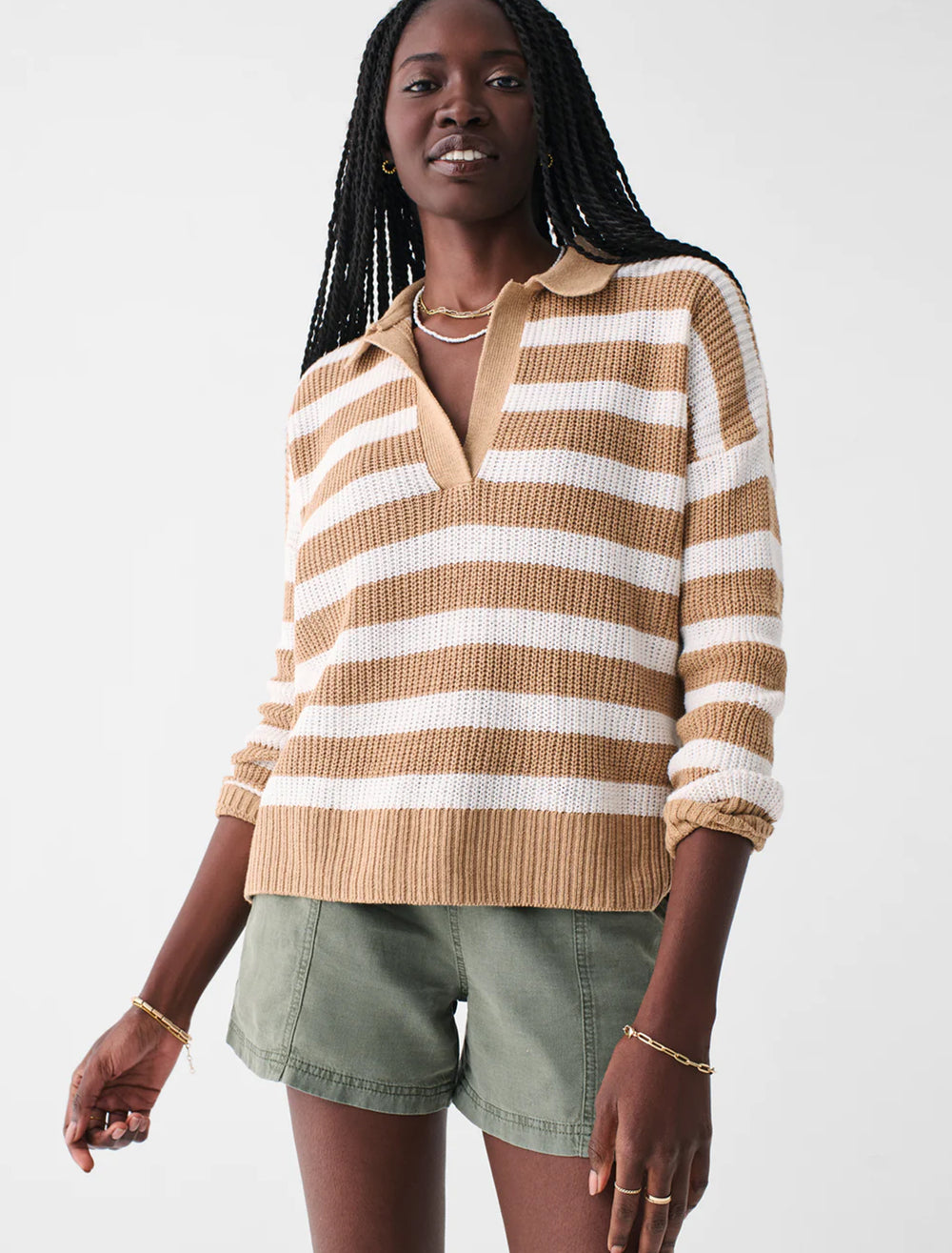 Model wearing Faherty's miramar polo in natural stripe.