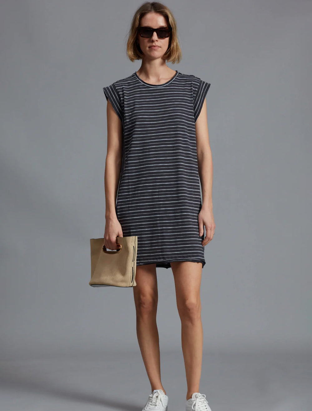 Model wearing Rag & Bone's jersey muscle dress black multi stripe.