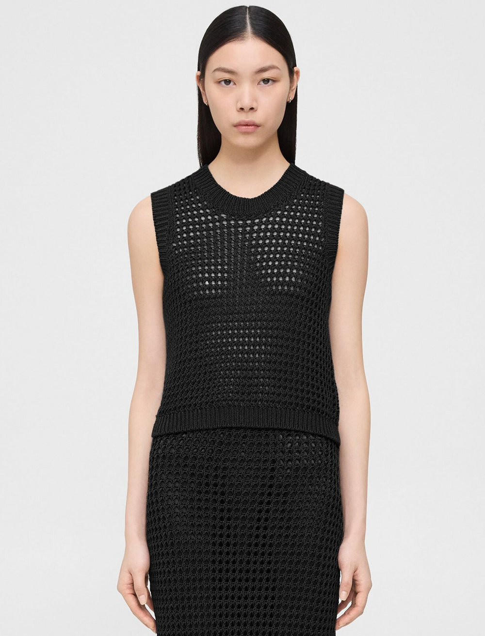 Model wearing Theory's crew neck vest in black.