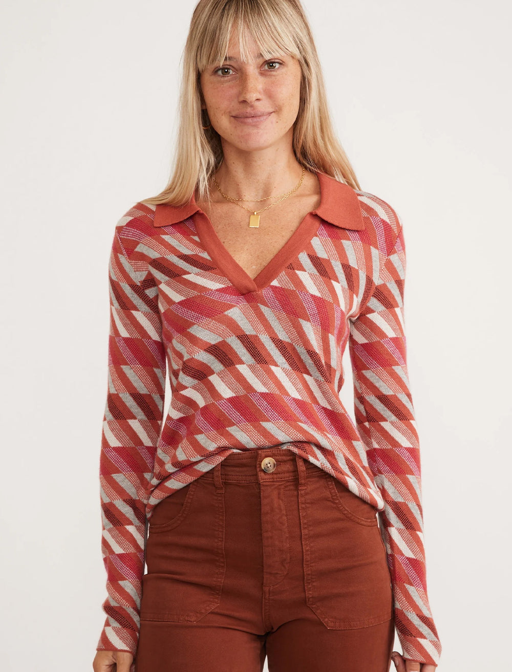 Model wearing Marine Layer's novelty sweater polo in warm multi.