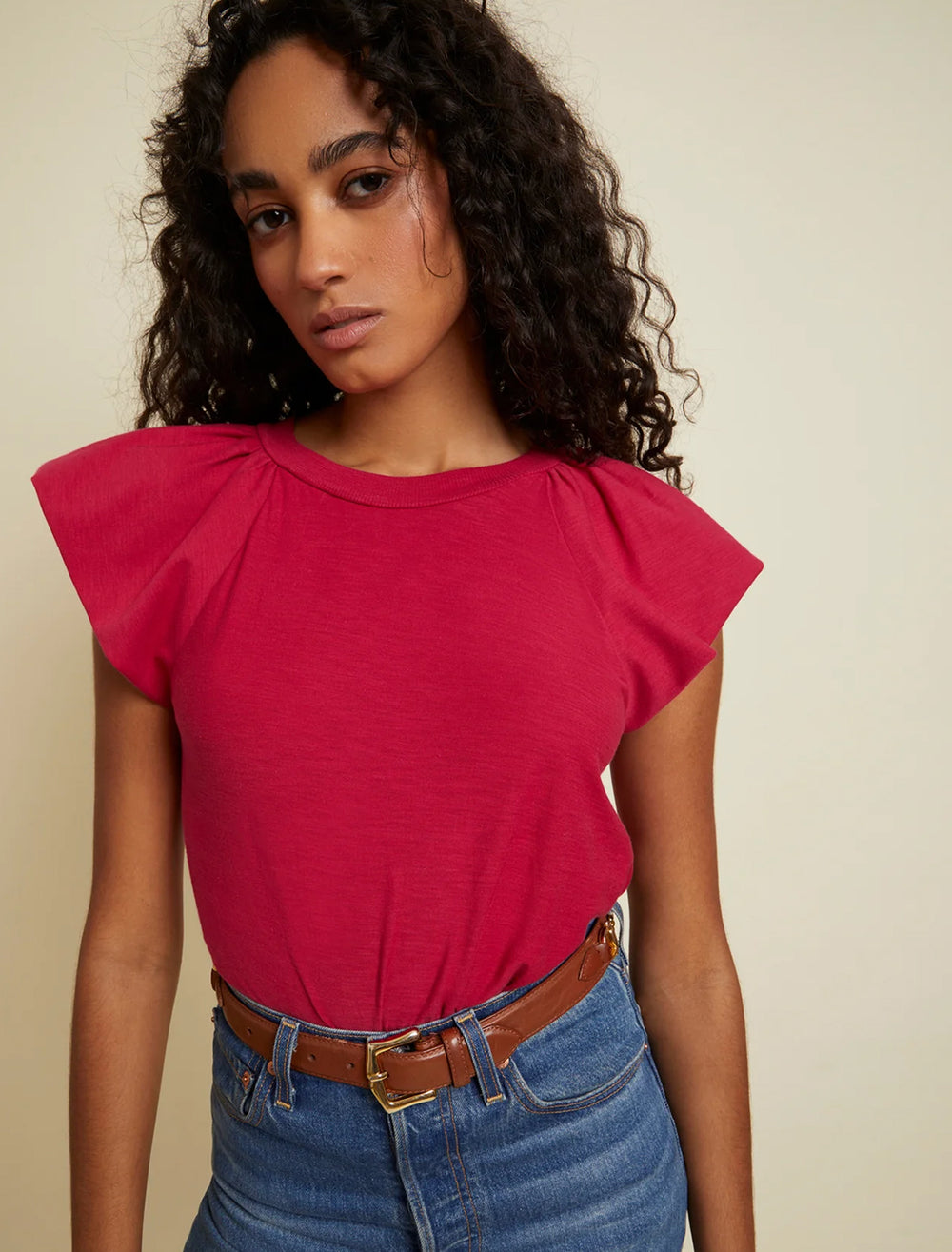 Model wearing Nation LTD's lorna ruffle tank in raspberry.
