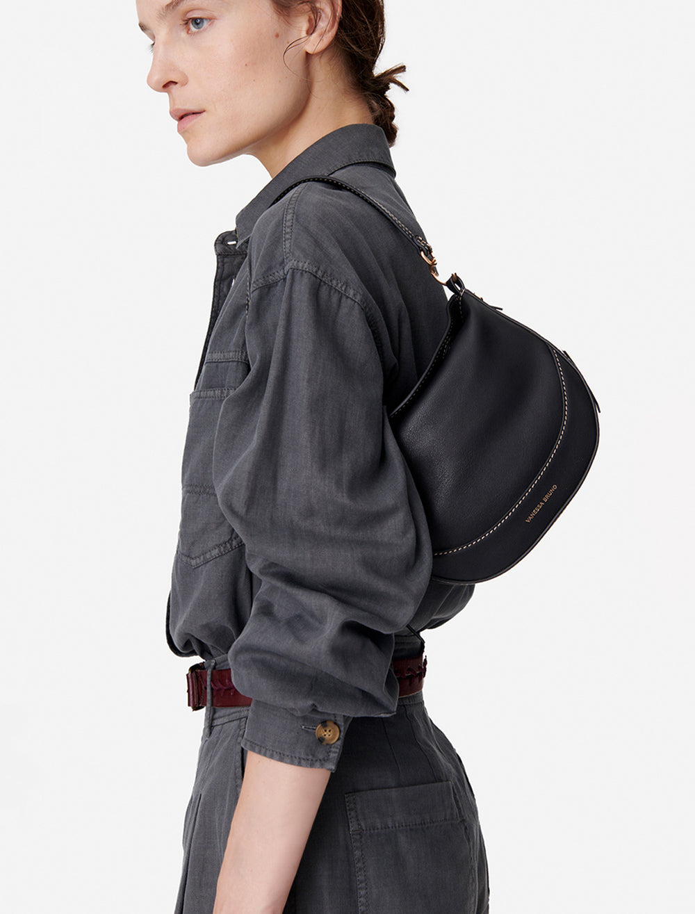 Model holding Vanessa Bruno's mini daily bag in noir.