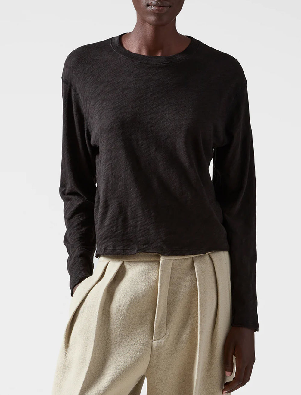 Model wearing ATM's slub jersey long sleeve destroyed crop tee in black.