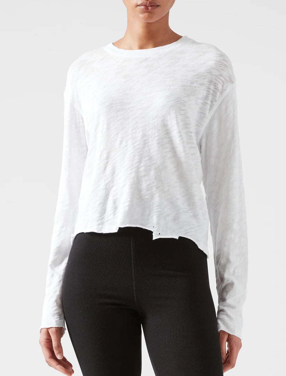 Model wearing ATM's slub jersey long sleeve destroyed crop tee in white.