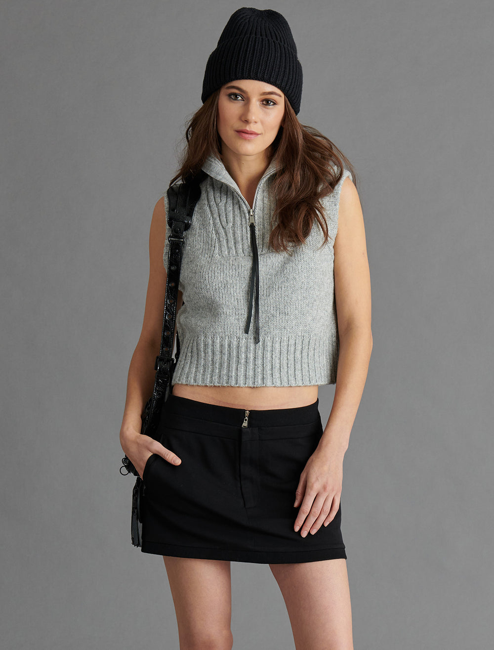Model wearing Steve Madden's karter sweater vest in heather grey.