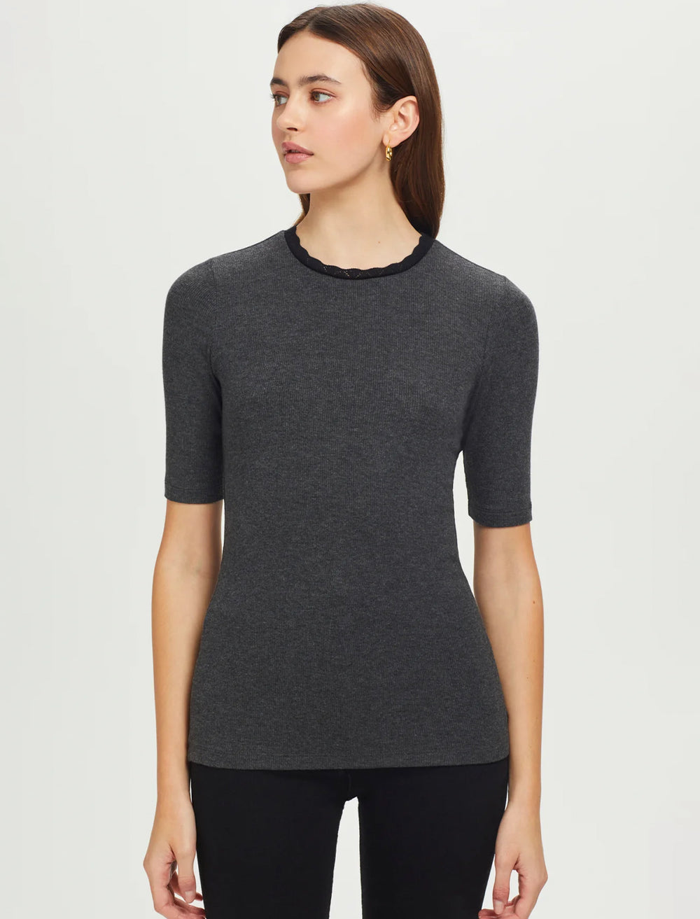 Model wearing Goldie Lewinter's half sleeve pointell trim rib tee in charcoal.