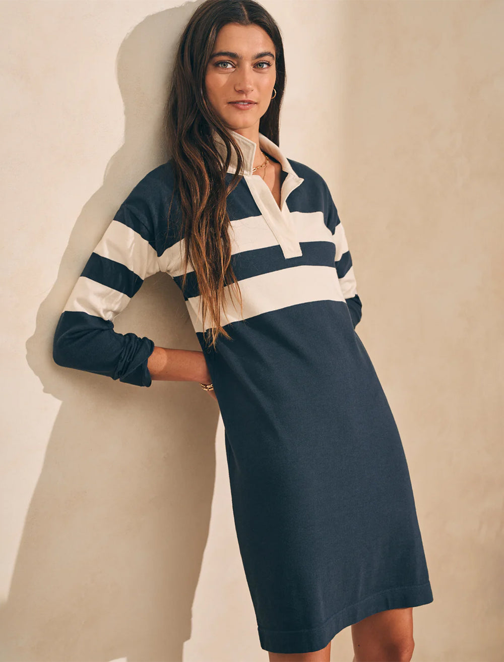 Model wearing Faherty's rugby jersey polo dress in open stripe.