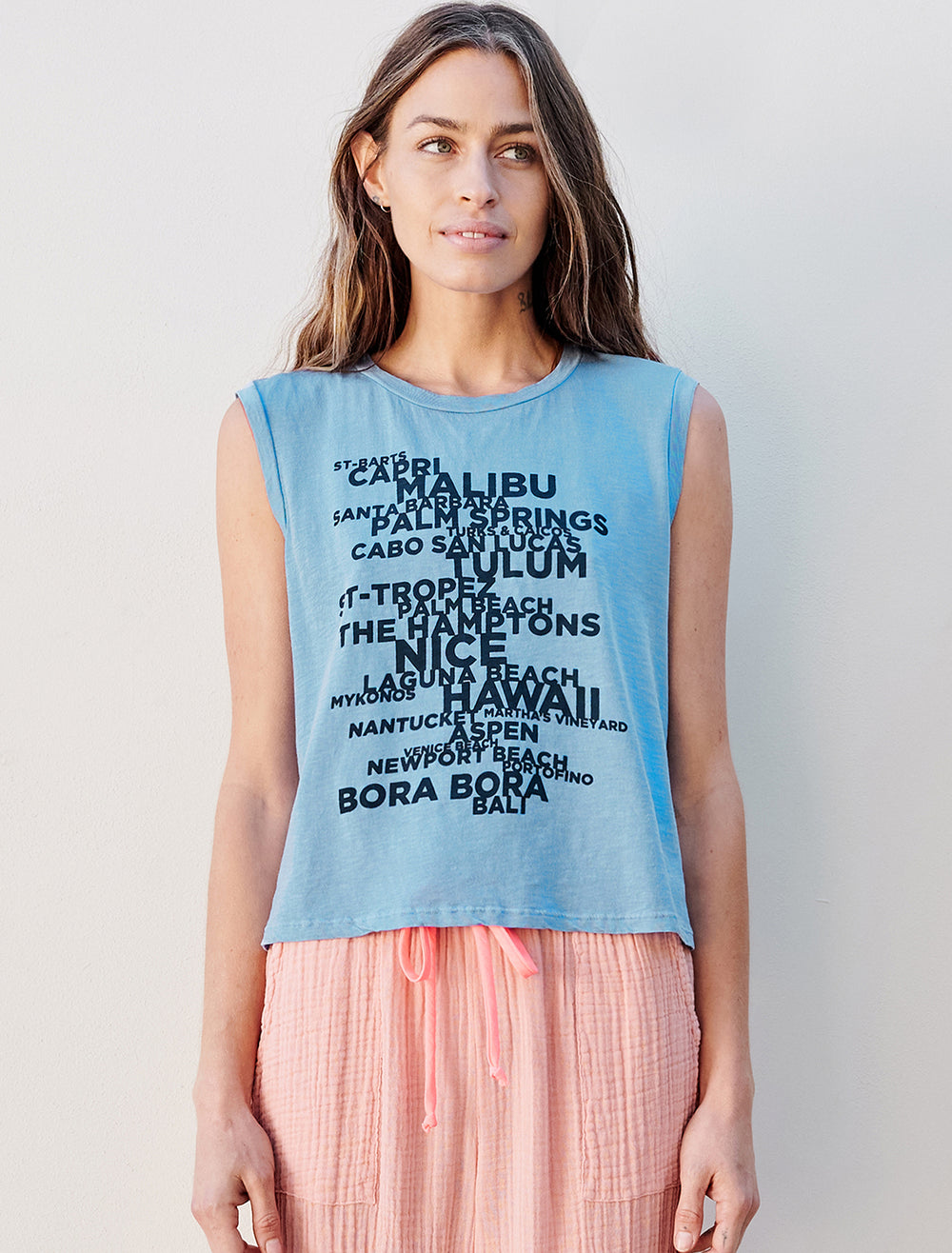 Model wearing Sundry's destinations muscle tank in pigment capri.