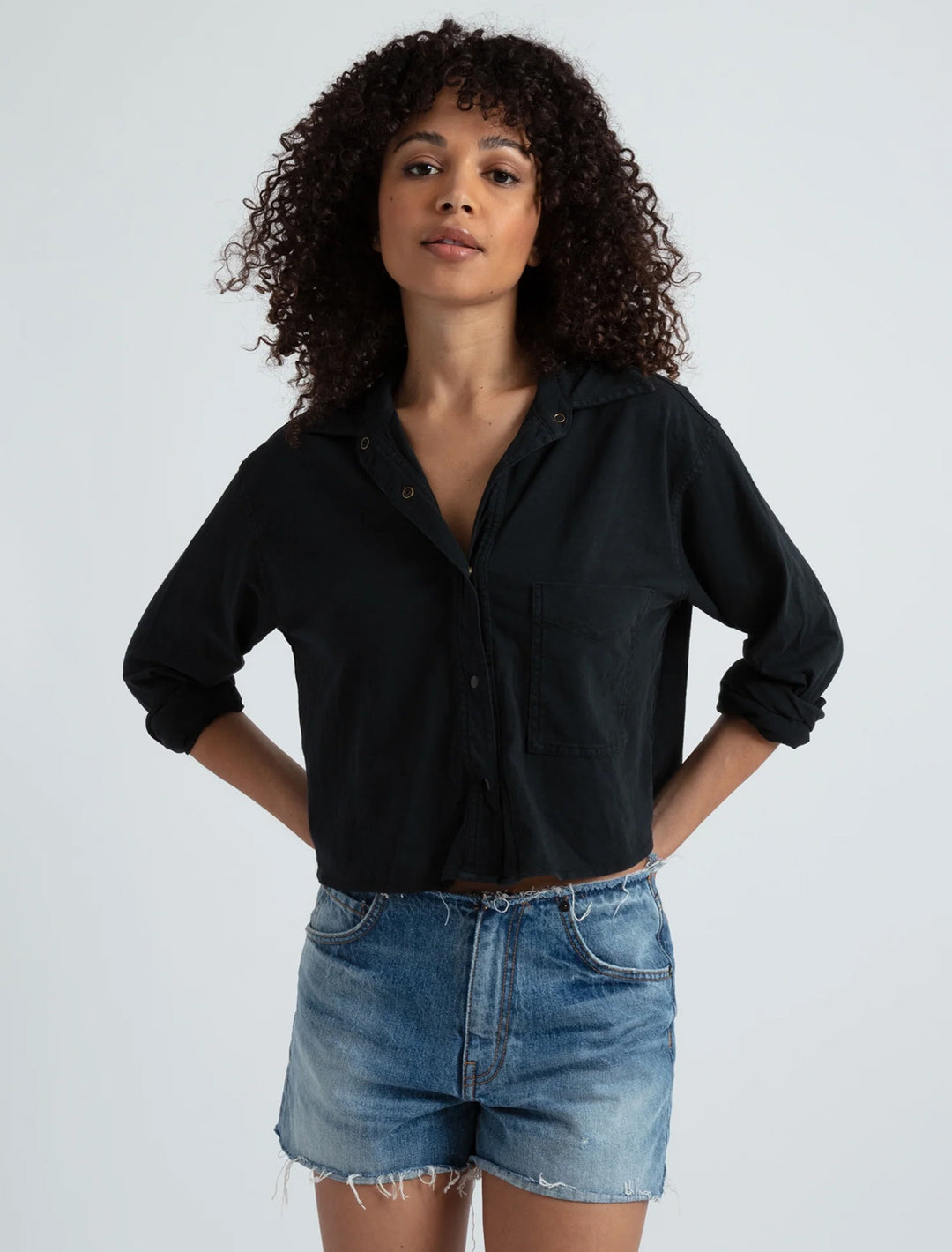 Model wearing ASKK NY's crop knit shirt in stone black.