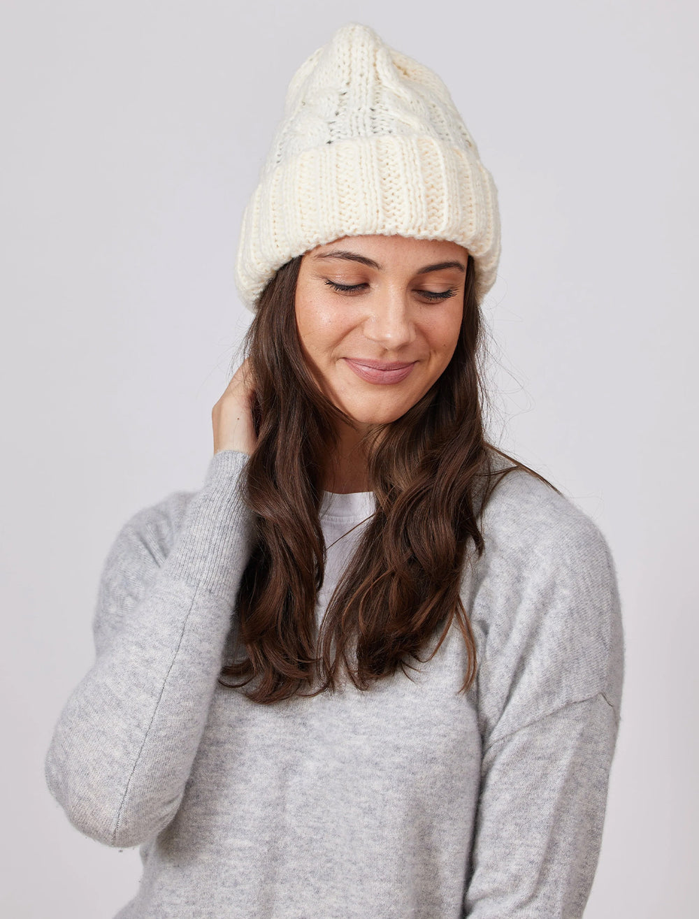 Model wearing Hat Attack's fisherman beanie in ivory.