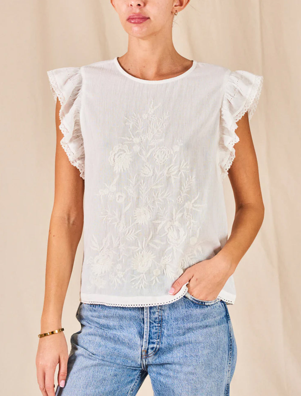 Model wearing M.A.B.E.'s estella embroidered top in white.
