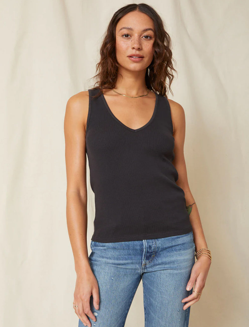 Model wearing AMO's deeply tank in vintage black.