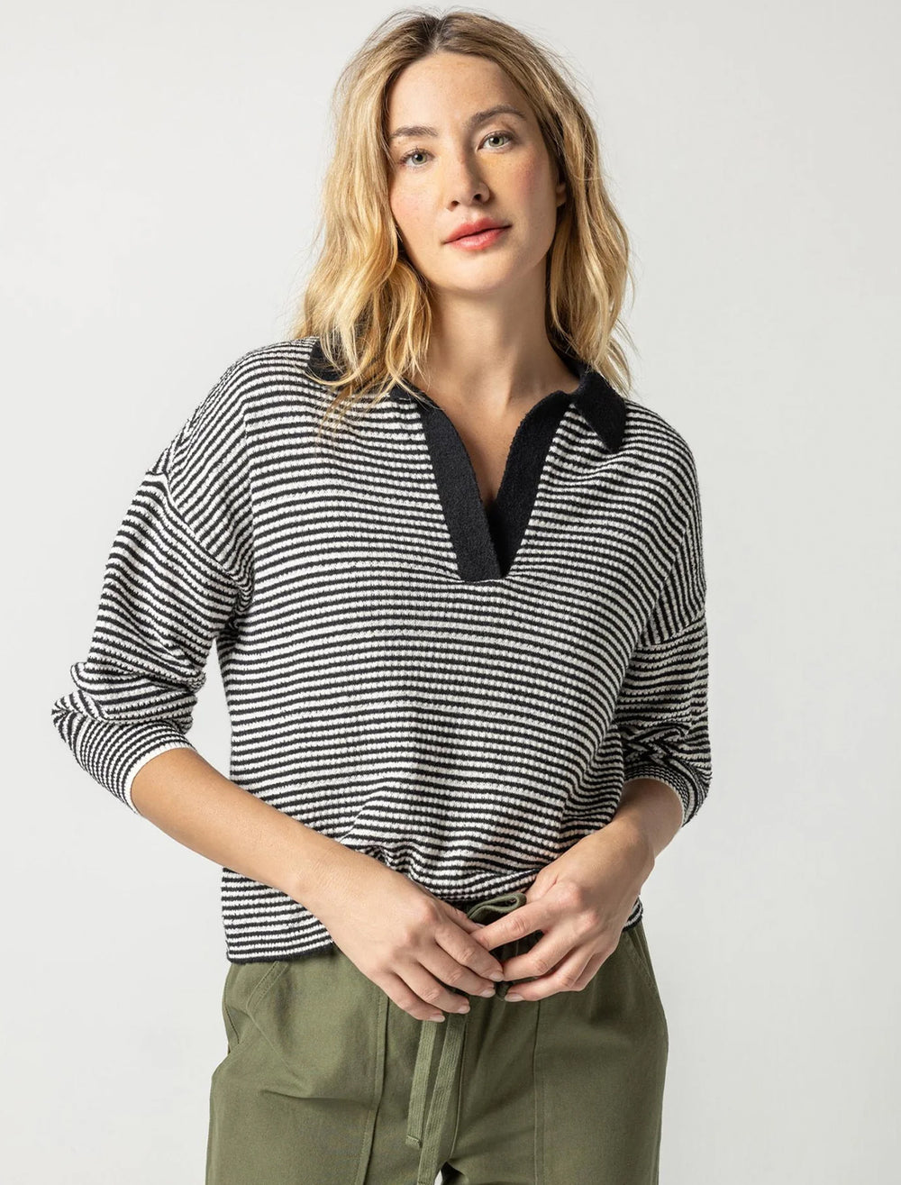 Model wearing Lilla P.'s easy polo sweater in black and ivory.