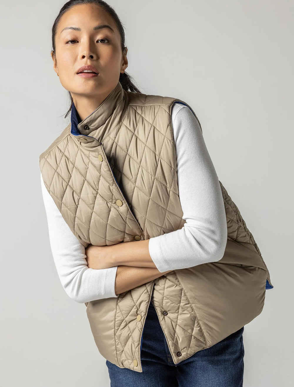 Model wearing the reverse side of Lilla P.'s reversible snap front vest in sapphire.