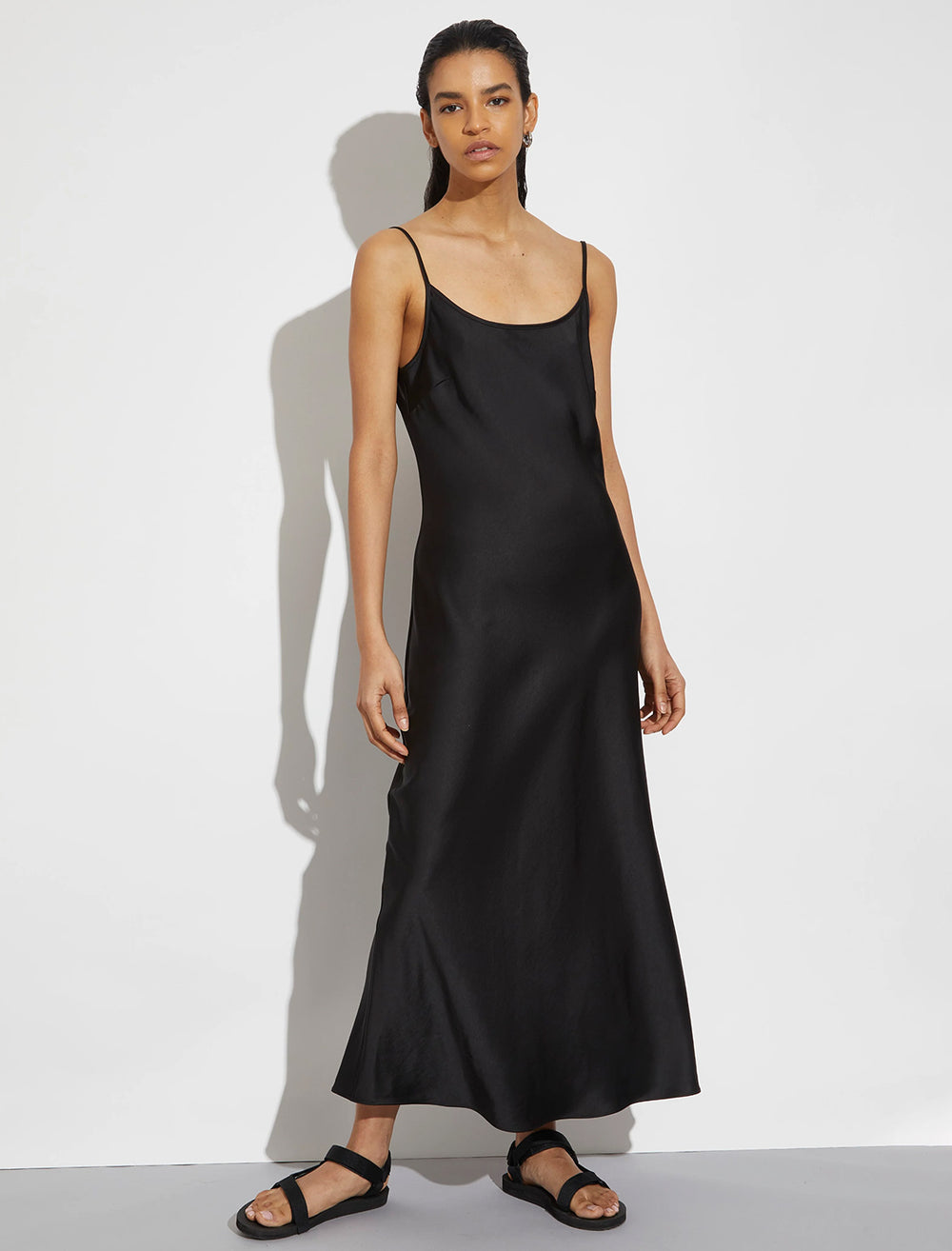 Model wearing Saint Art's haley slip dress in black.