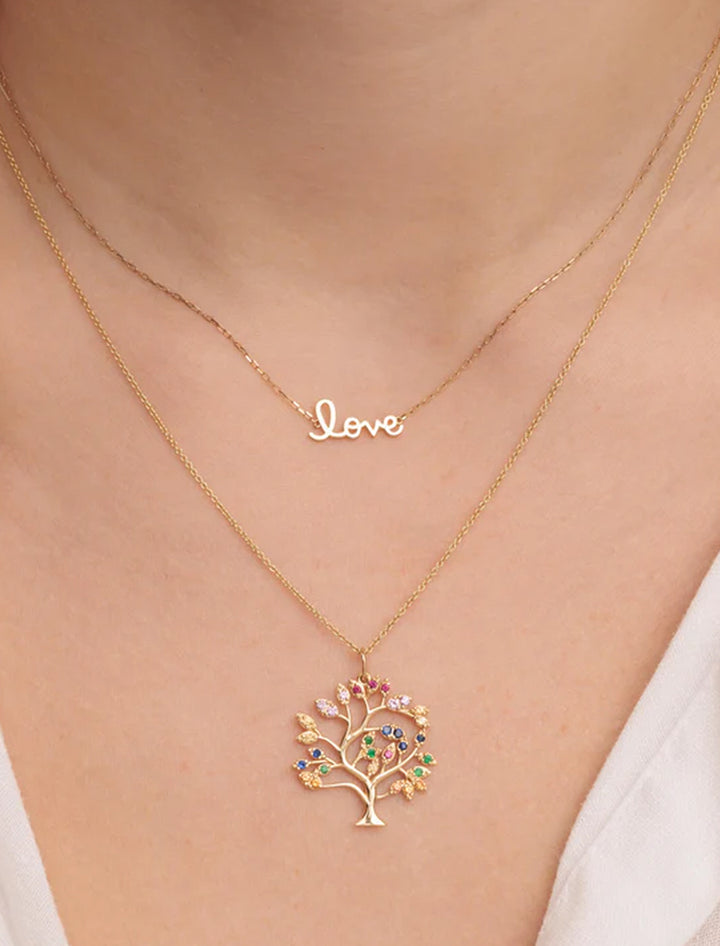 Model wearing Sydney Evan's tiny pure love script necklace.