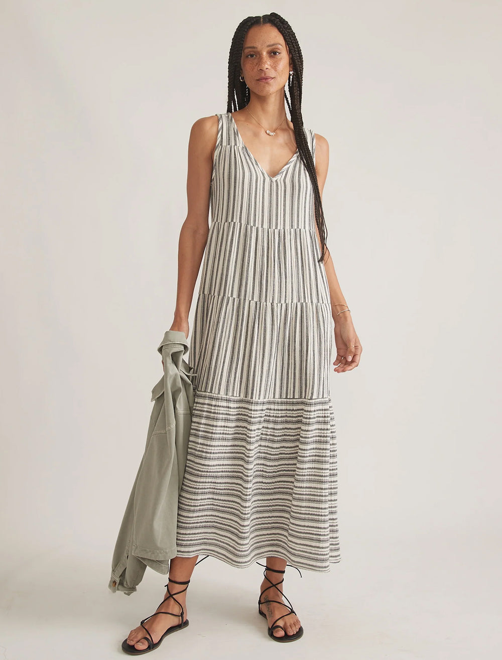Model wearing Marine Layer's corinne maxi dress in mixed black and white stripe.