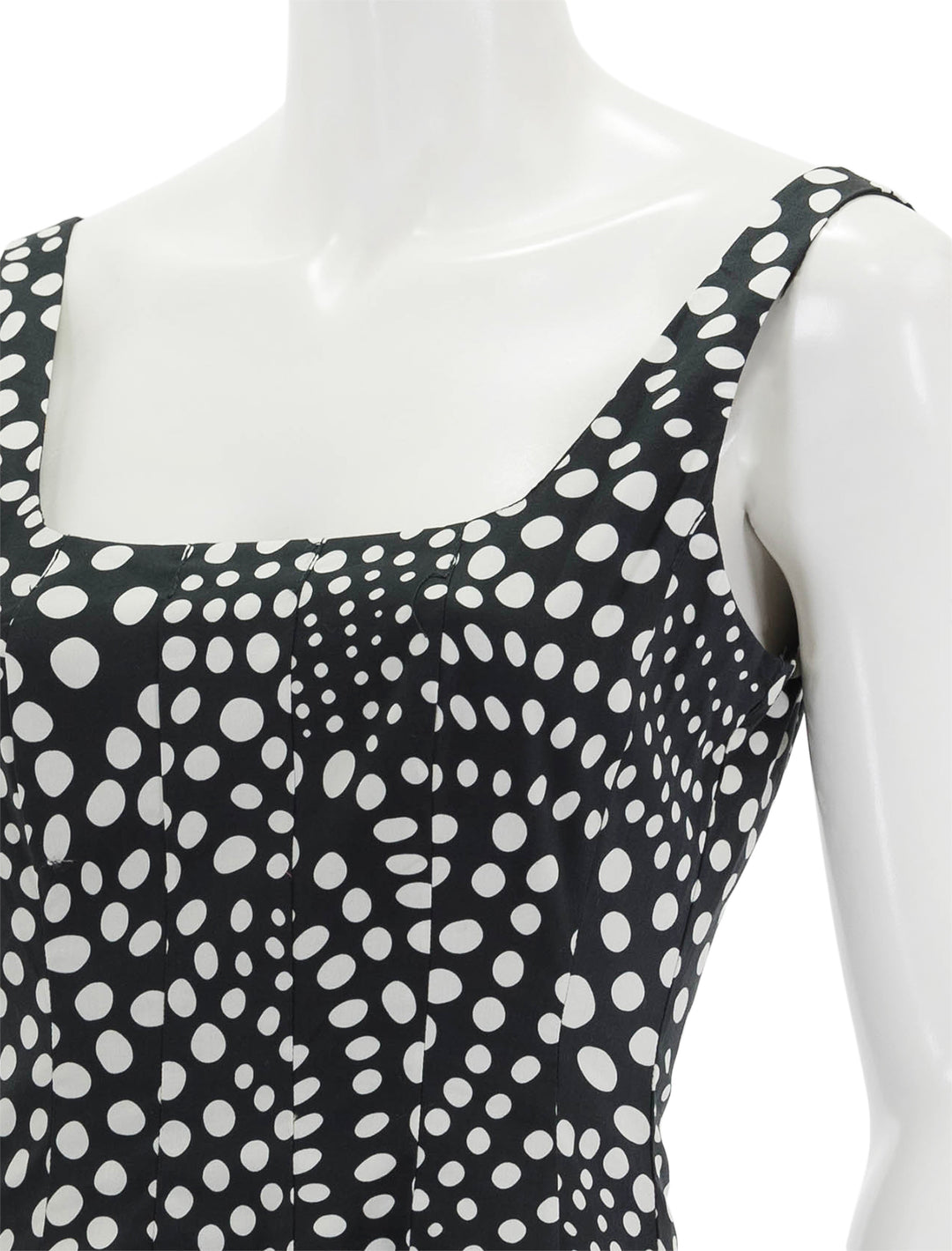 Close-up view of STAUD's mini wells dress in black wavy dot.