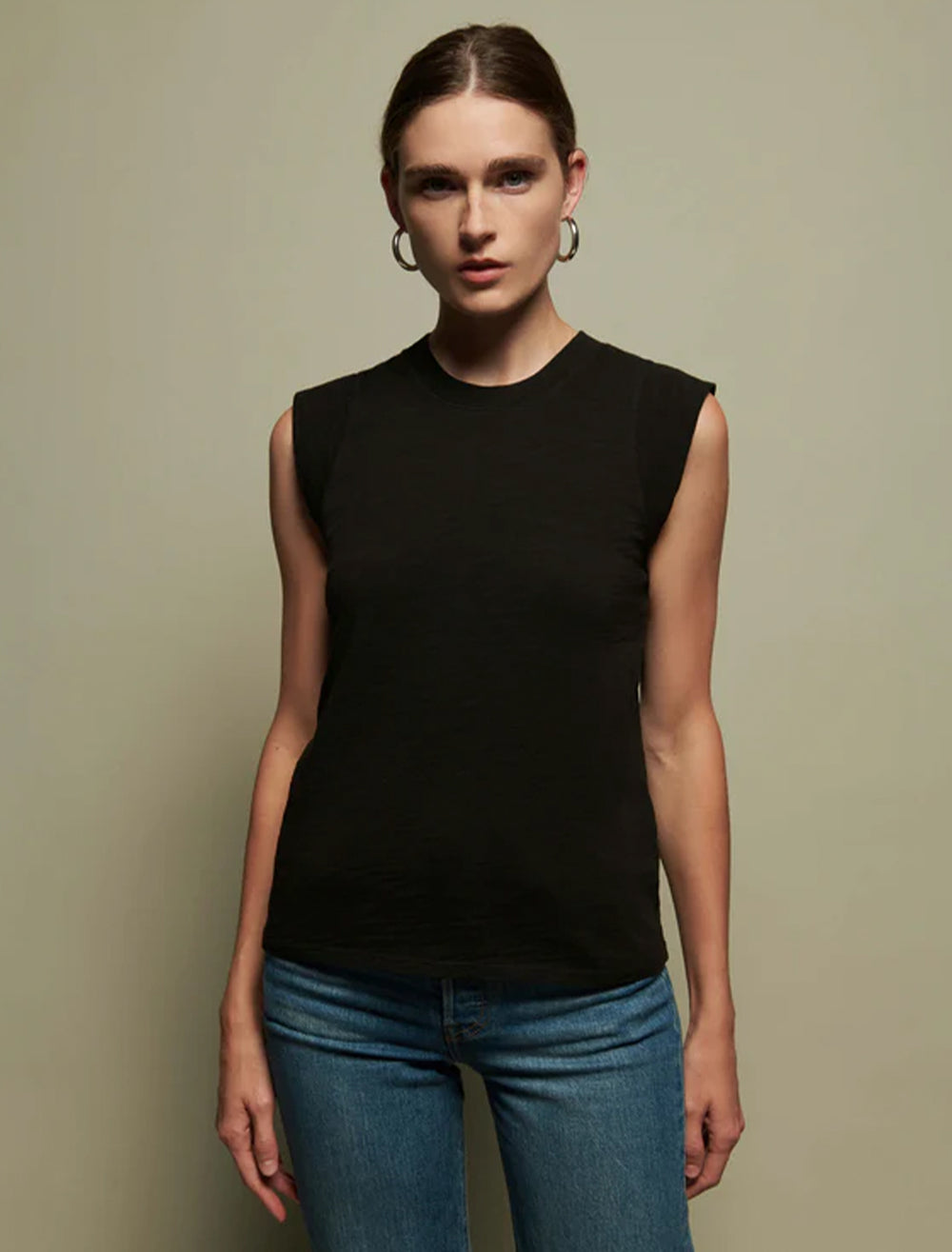 Model wearing Nation LTD's patti muscle tank in jet black.