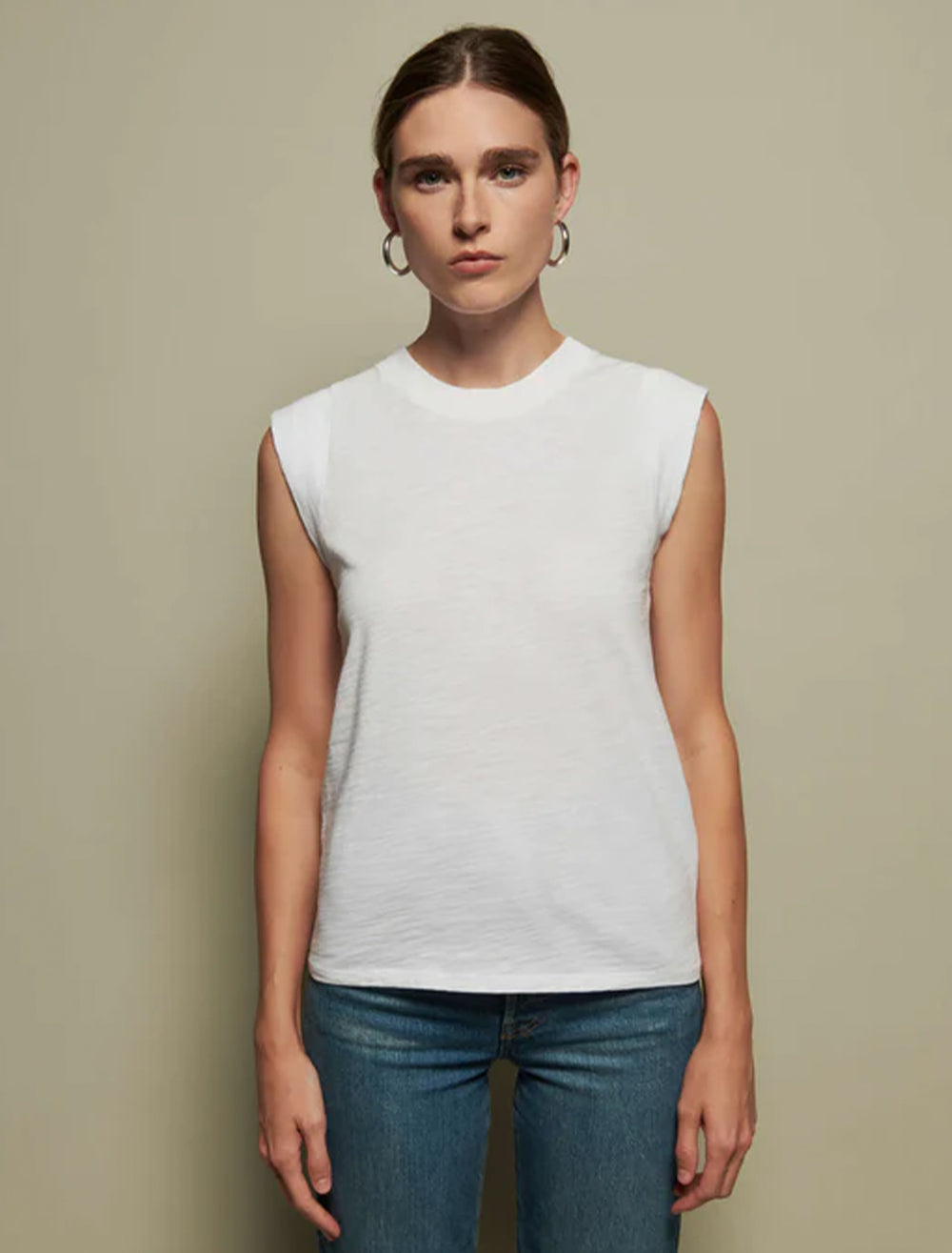 Model wearing Nation LTD's patti muscle tank in optic white.