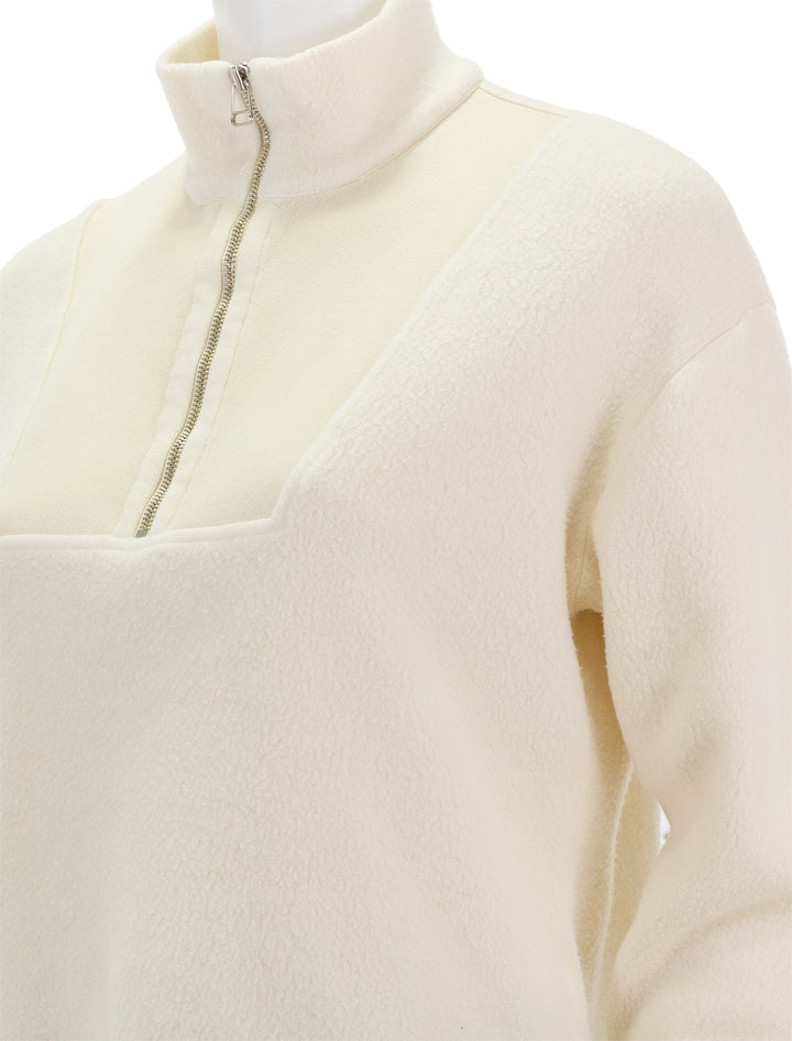 Close-up view of Sundry's sherpa 1/4 zip sweatshirt in cream.