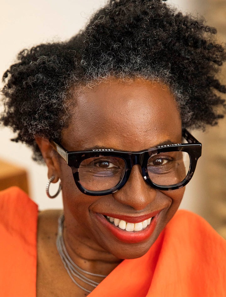 Model wearing Caddis' D28 in black tortoise.