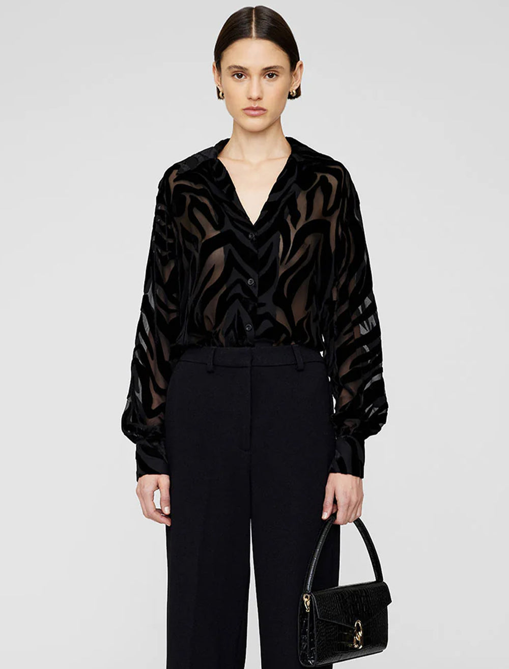 Model wearing Anine Bing's mylah top in black zebra burnout.