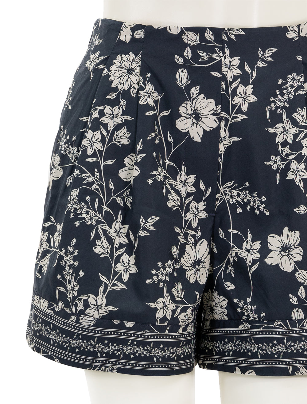 Close-up view of Cara Cara's trish shorts in evening meadow mist.