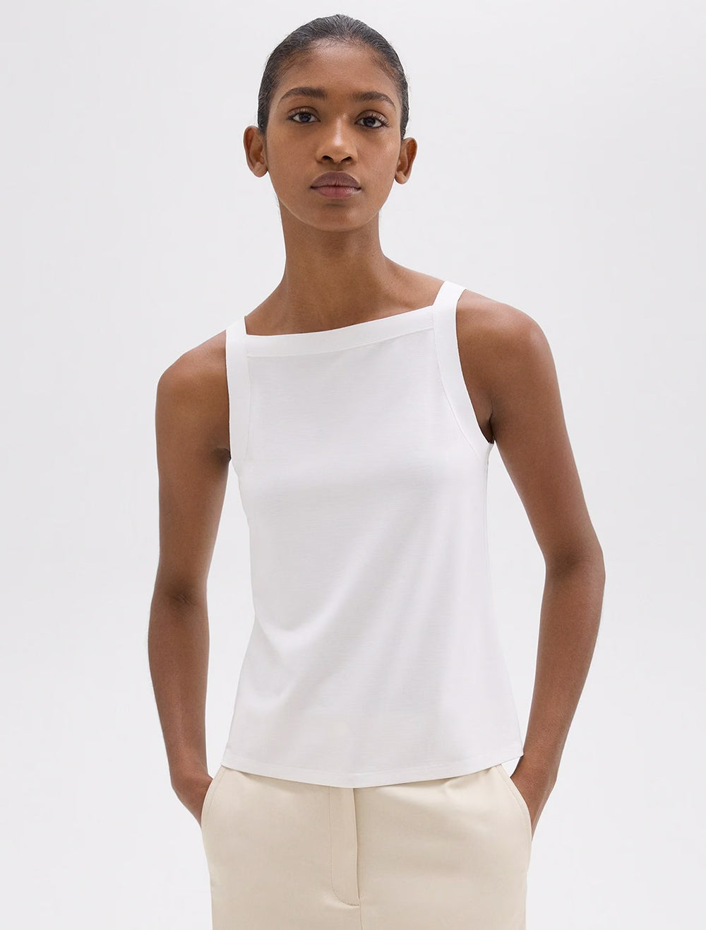 Model wearing Theory's square high neck tank in white.