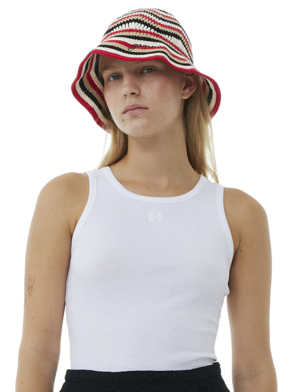 Model wearing GANNI's cotton crochet bucket hat in racing red.