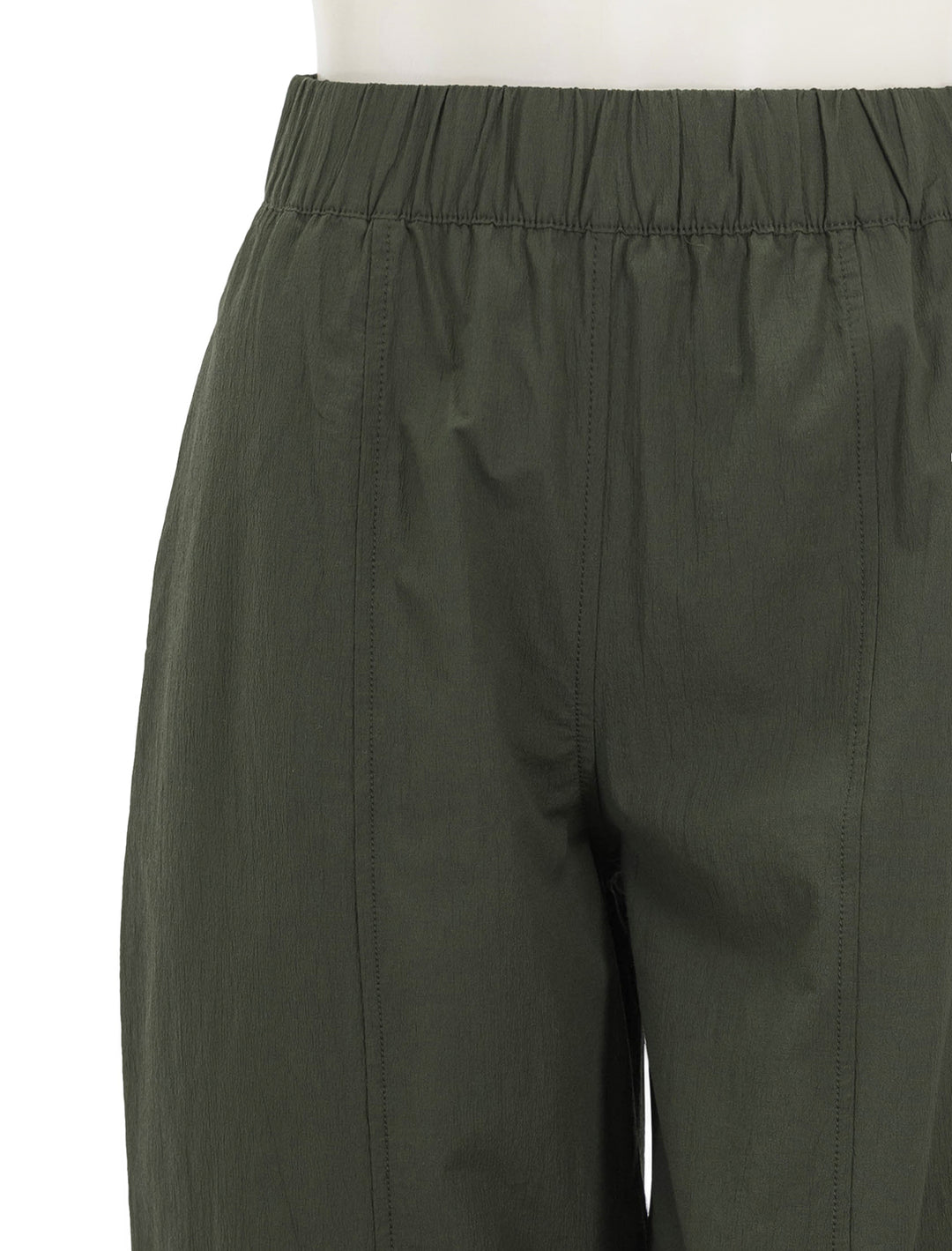 Close-up view of GANNI's curve pant in kombu green.