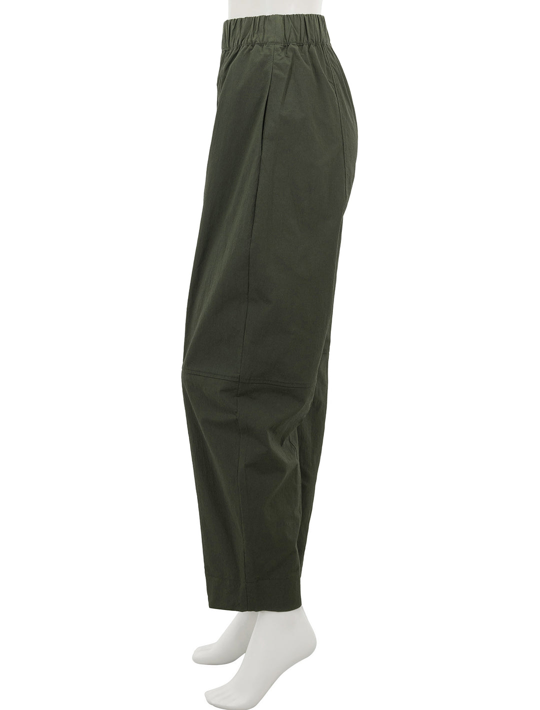 Side view of GANNI's curve pant in kombu green.