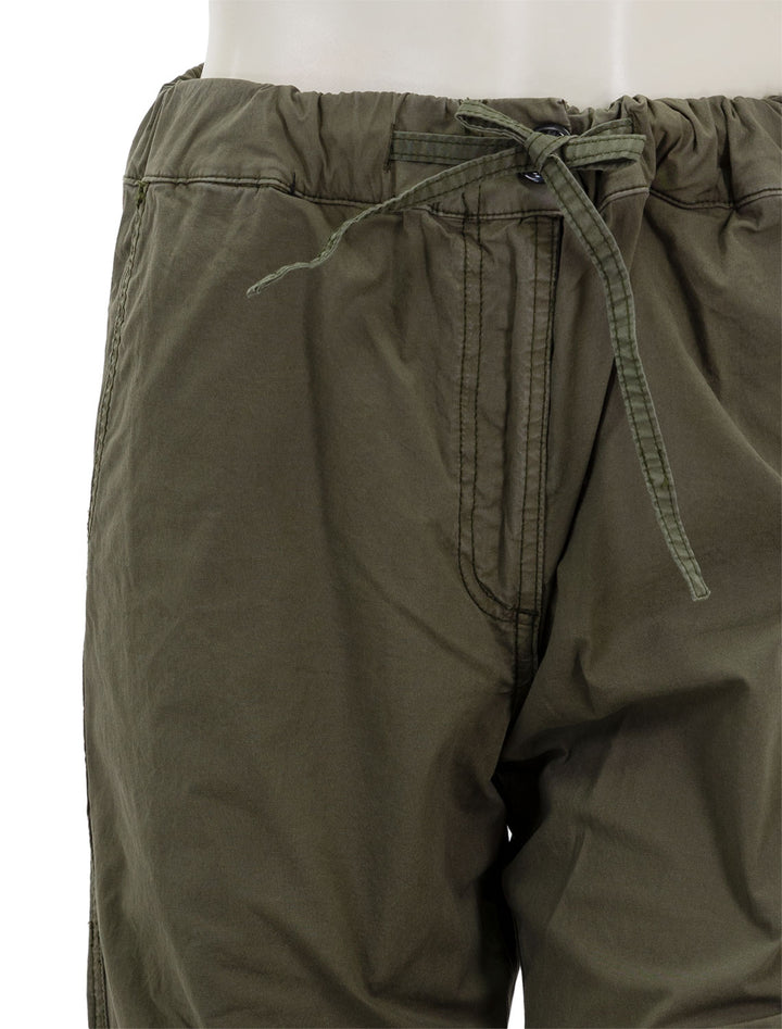Close-up view of GANNI's washed cotton drawstring pants in kalamata.