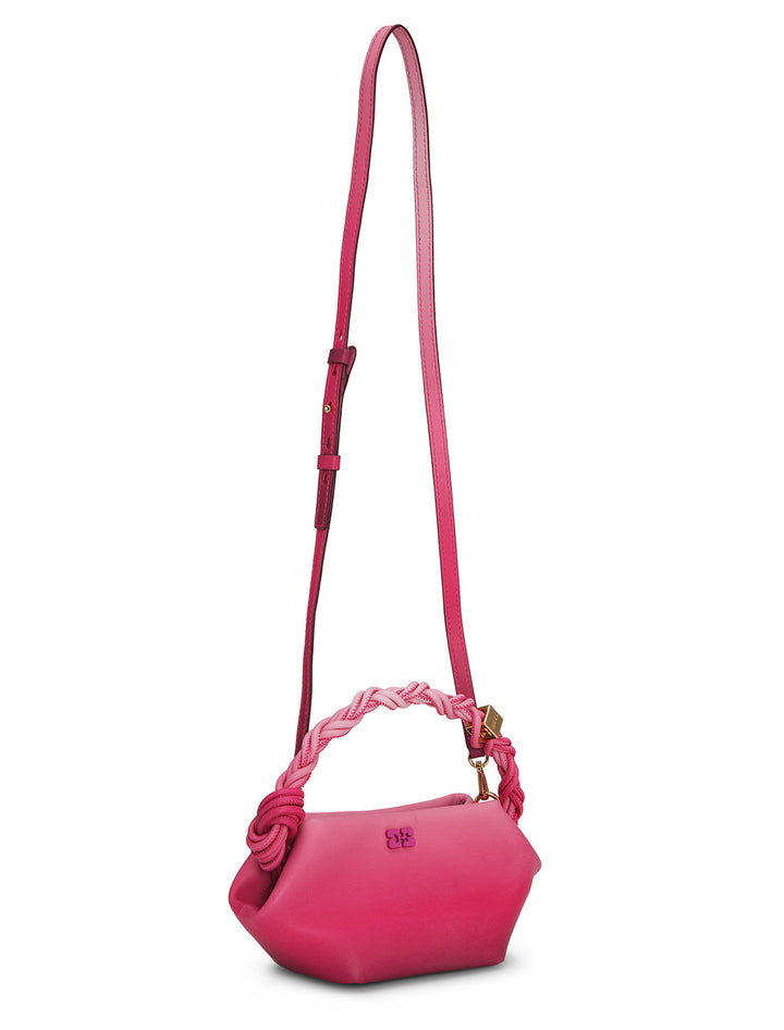 View of GANNI's mini bou bag in gradient pink with shoulder strap.