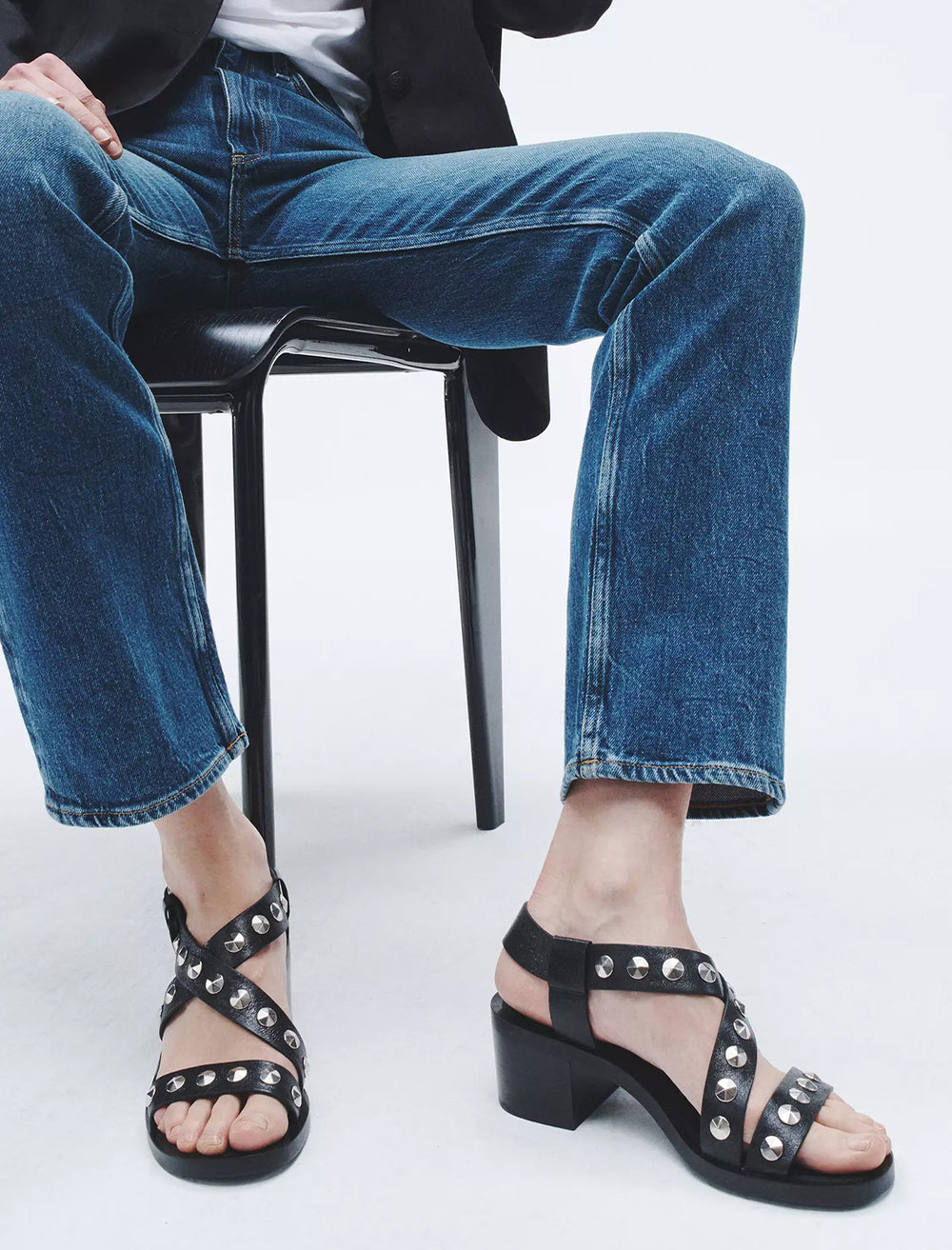 Model wearing Rag & Bone's geo stud block heel sandal in black.