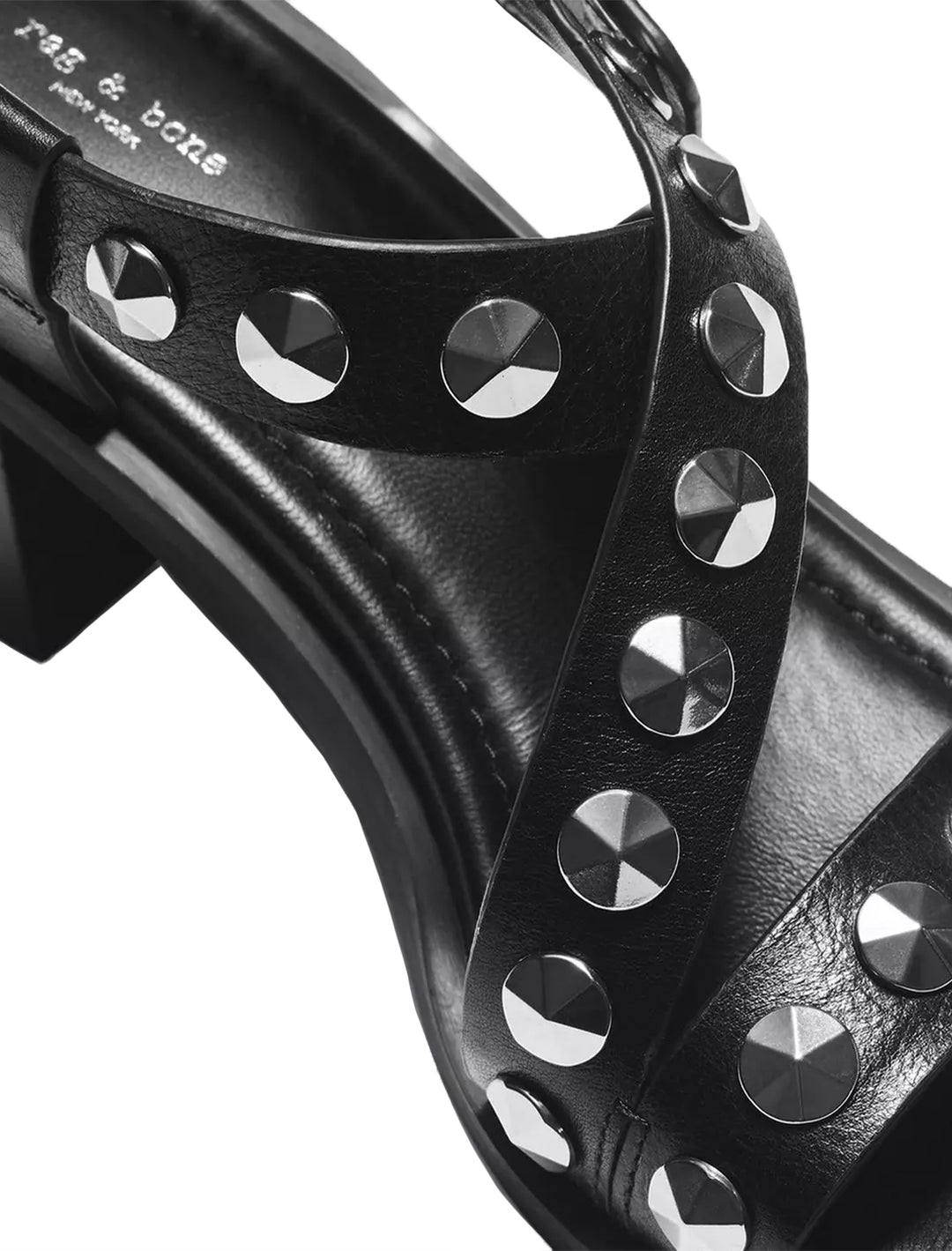 Close-up view of Rag & Bone's geo stud block heel sandal in black.