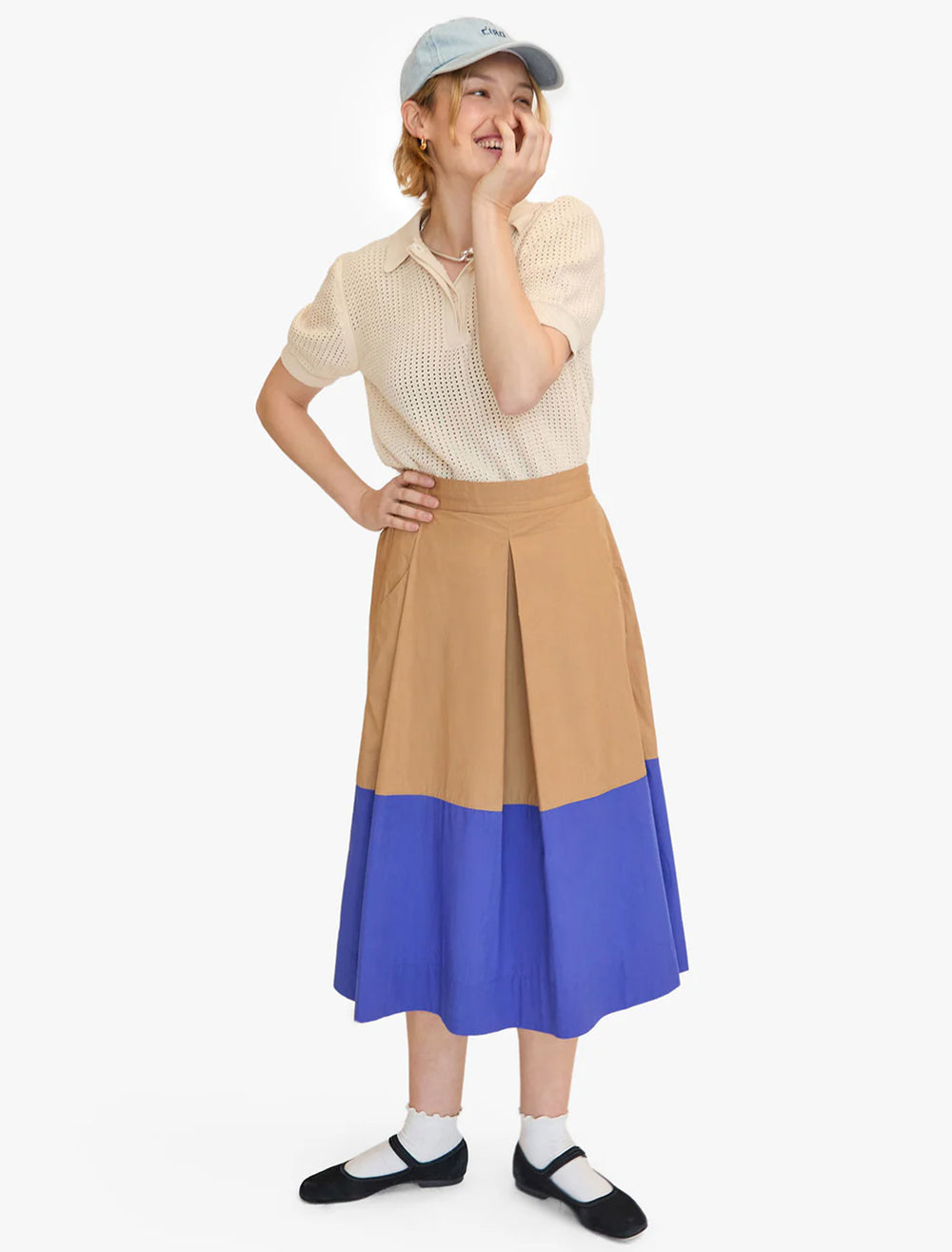 Model wearing Clare V.'s genevieve skirt in khaki and cobalt.
