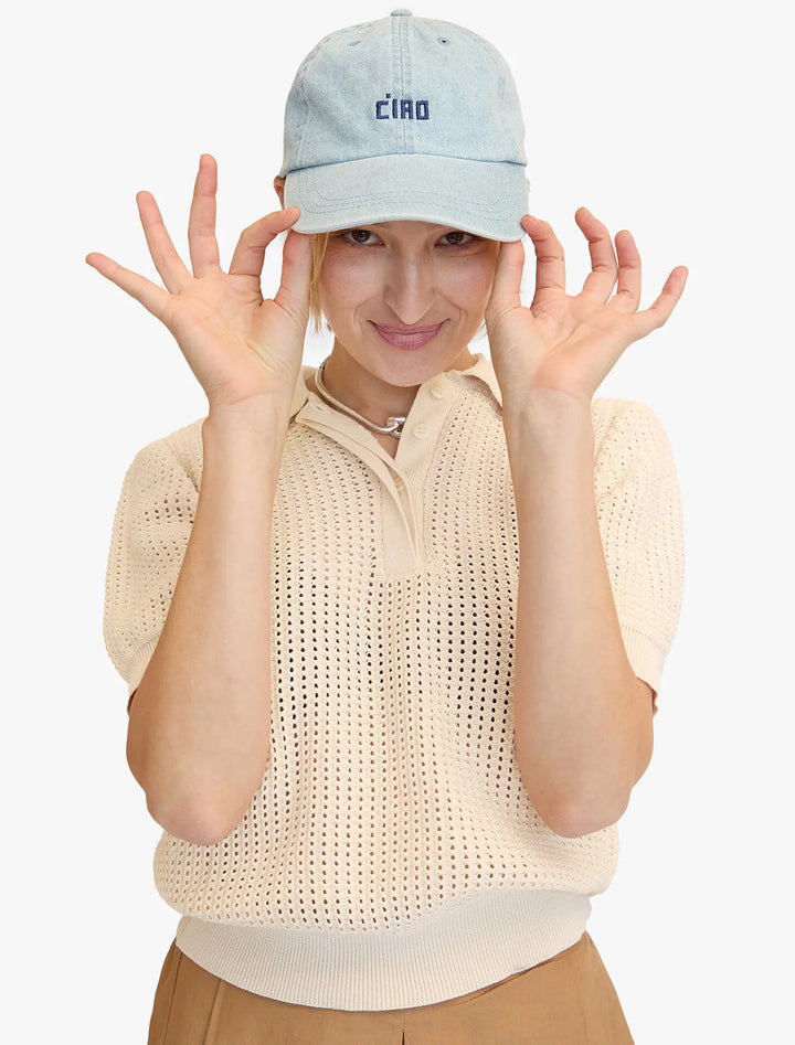 Model wearing Clare V.'s baseball hat in light denim.