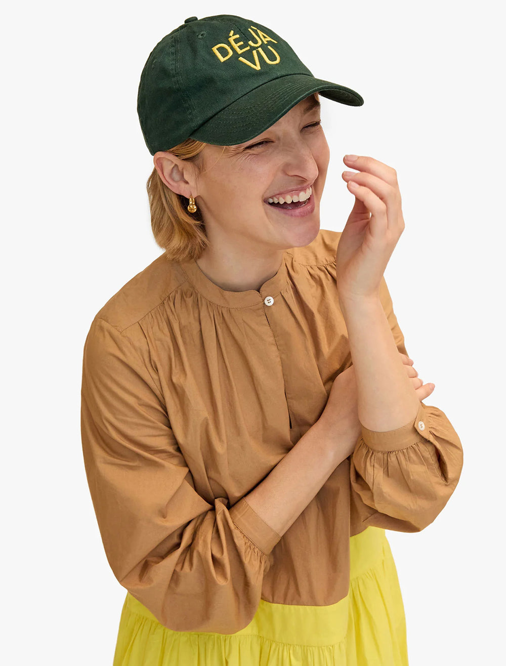 Model wearing Clare V.'s baseball hat in forest and marigold.