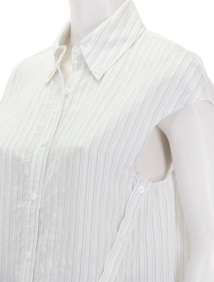 Close-up view of Saint Art's perth cap sleeve button blouse in off white pinstripe.