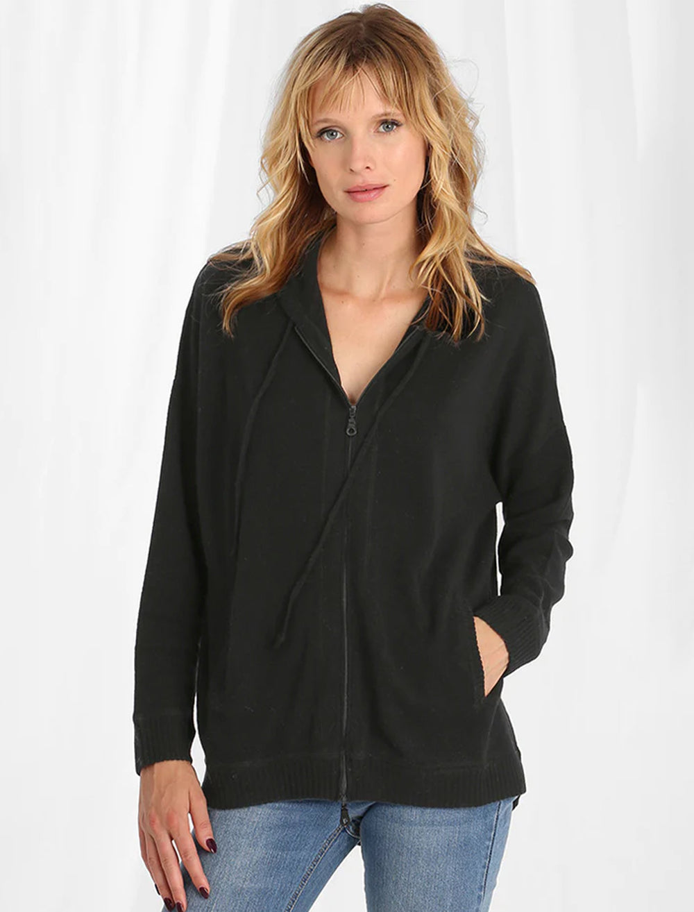 Model wearing Minnie Rose's cashmere oversize zip hoodie in black.