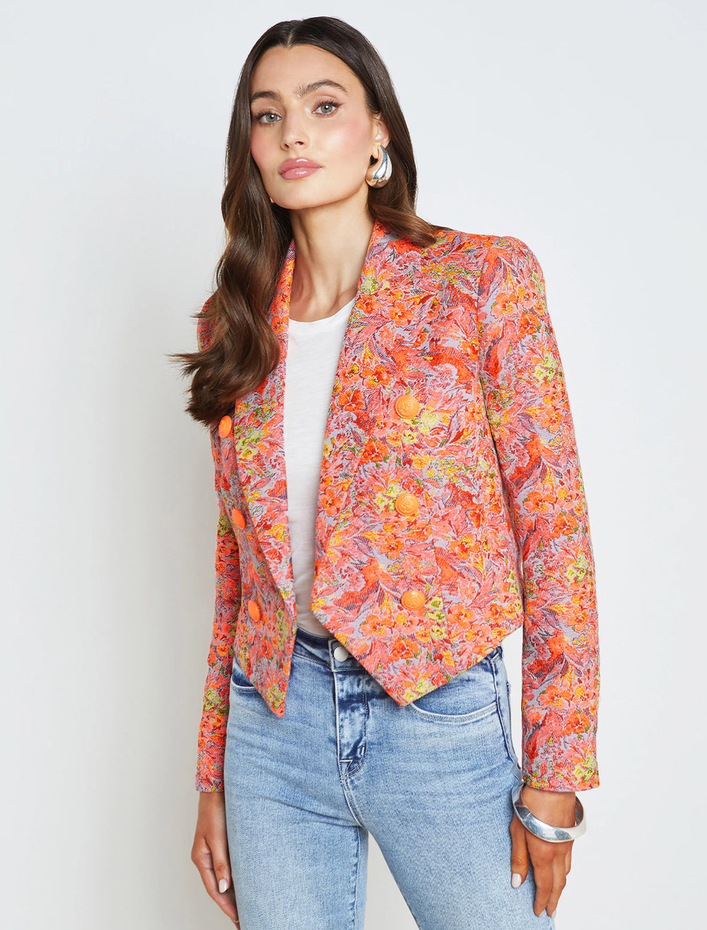 Model wearing L'agence's lila boxy blazer in orange floral.